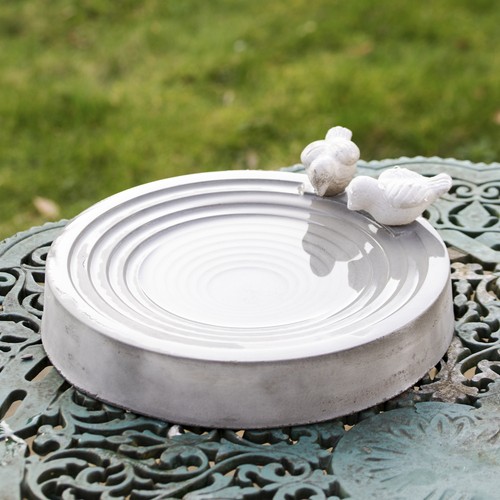 Concrete round bird bath with - bird,